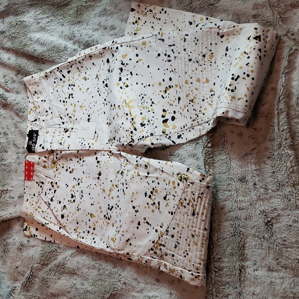 Red Ape white skinny jeans size 12 boys with black and gold paint platters. New